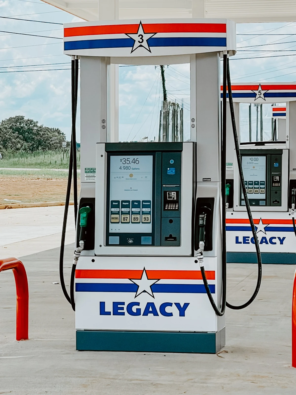 Fuel dispensers beneath a station canopy